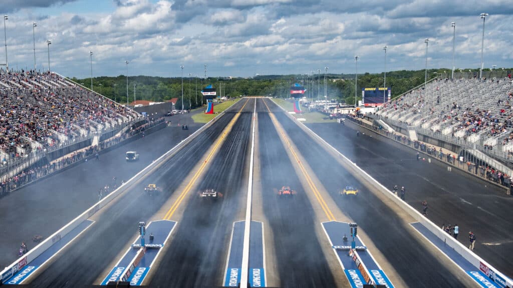 cars in motion in a "four-wide" race at zmax dragway at charlotte motor speedway