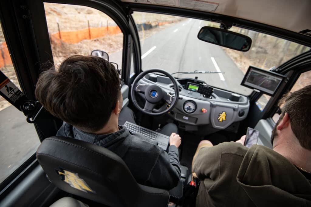 daniel tobias and automoblog writer david straughan ride in the nc a&t self-driving shuttle