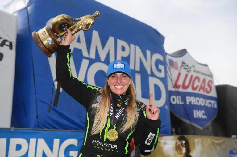 brittany force holds a trophy following a victory